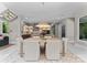Elegant dining area with a stylish light fixture and seamless transition to the modern kitchen at 188 Blarney Rd, Mooresville, NC 28117