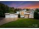 Stunning modern home with three-car garage and manicured lawn at twilight at 188 Blarney Rd, Mooresville, NC 28117
