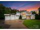 Stunning modern home with three-car garage and manicured lawn at twilight at 188 Blarney Rd, Mooresville, NC 28117