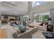 Open-concept living room with ample seating, large windows, and a view into the modern kitchen at 188 Blarney Rd, Mooresville, NC 28117