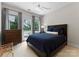 Comfortable main bedroom with blue comforter, deck access, and elegant natural light at 188 Blarney Rd, Mooresville, NC 28117