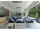 The covered patio features multiple seating areas, modern furniture and a fan system at 188 Blarney Rd, Mooresville, NC 28117