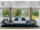 Inviting covered patio featuring stylish outdoor furniture, ceiling fans, and serene views at 188 Blarney Rd, Mooresville, NC 28117
