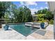 A private swimming pool with waterfalls in the backyard, surrounded by trees and a lake view at 188 Blarney Rd, Mooresville, NC 28117