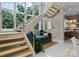 Contemporary staircase with floating wood treads, metal railings, and a cozy reading nook at 188 Blarney Rd, Mooresville, NC 28117