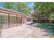 Spacious backyard with a concrete patio, lush greenery, and mature trees at 2000 Tyvola Rd, Charlotte, NC 28210