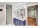 Elegant bathroom featuring double sinks, sleek black faucets, modern lighting, and a luxurious marble-tiled shower at 2000 Tyvola Rd, Charlotte, NC 28210