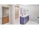Well-lit bathroom vanity with double sinks, stylish square mirror, and adjacent closet space at 2000 Tyvola Rd, Charlotte, NC 28210