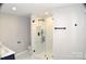 Bathroom featuring glass enclosed shower with marble tile and modern black hardware at 2000 Tyvola Rd, Charlotte, NC 28210