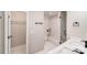 Bathroom with double sinks, walk-in closet, shower and marble tile at 2000 Tyvola Rd, Charlotte, NC 28210