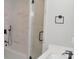 Bathroom featuring a glass enclosed shower with marble tile and black hardware at 2000 Tyvola Rd, Charlotte, NC 28210