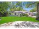 Charming home with a digitally enhanced lush green front yard, mature trees, and a welcoming exterior at 2000 Tyvola Rd, Charlotte, NC 28210
