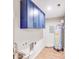 Functional laundry area with blue cabinets and a utility sink next to a hot water heater and hookups at 2000 Tyvola Rd, Charlotte, NC 28210