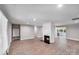 Light-filled living room with wood floors, recessed lights, and a charming brick fireplace at 2000 Tyvola Rd, Charlotte, NC 28210