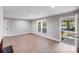 Spacious living room with light wood floors, neutral walls, and an abundance of natural light at 2000 Tyvola Rd, Charlotte, NC 28210