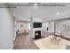 Virtually staged living room with a wood-burning fireplace and an open-concept layout at 2000 Tyvola Rd, Charlotte, NC 28210