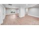 Bright living room featuring wood floors, a painted brick fireplace, and recessed lighting at 2000 Tyvola Rd, Charlotte, NC 28210