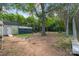 Spacious backyard featuring lush greenery, a small pool, trampoline, and storage shed at 2201 Grimes St, Charlotte, NC 28206