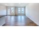 Bright living room with wood flooring and three large windows at 2541 Ruby Dixon Crossing Dr # 18, Gastonia, NC 28056
