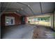 Covered carport near a brick home, with doors to the interior, and view to the backyard at 2865 Water Plant Rd, Maiden, NC 28650