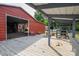 Open deck with an overhanging roof, a red barn, and several potted plants at 2865 Water Plant Rd, Maiden, NC 28650