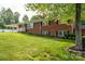 Brick home featuring manicured landscaping, black shutters, and a covered side porch on a sunny day at 2865 Water Plant Rd, Maiden, NC 28650