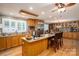 Spacious kitchen featuring a center island, stainless steel appliances, and an abundance of custom wood cabinetry at 2865 Water Plant Rd, Maiden, NC 28650