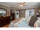 Inviting main bedroom featuring hardwood floors, ceiling fan and a barn-style sliding door at 2865 Water Plant Rd, Maiden, NC 28650