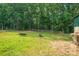 Pasture with green grass, a dark feeding trough, and a wooden fence at 2865 Water Plant Rd, Maiden, NC 28650