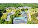 Aerial view of the commercial property, with a parking lot and plenty of mature trees surrounding the area at 3042 N Oxford St, Claremont, NC 28610