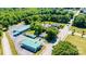 Expansive aerial view of commercial property featuring mature trees, ample parking, and street frontage at 3042 N Oxford St, Claremont, NC 28610