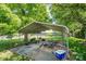 A metal shed in the backyard surrounded by trees and grass at 3042 N Oxford St, Claremont, NC 28610