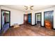 Empty room boasts natural light, hardwood floors, and access to additional rooms for versatile use at 3042 N Oxford St, Claremont, NC 28610