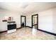 Basic kitchen features a white range and neutral-toned flooring, providing a functional space for cooking at 3042 N Oxford St, Claremont, NC 28610