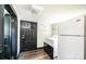 Functional laundry area features a washer, dryer, and refrigerator; door leads to another room at 3042 N Oxford St, Claremont, NC 28610