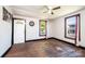A sunlit room features hardwood floors, a vintage ceiling fan, and classic dark trim work at 3042 N Oxford St, Claremont, NC 28610