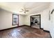 A room shows hardwood floors and dark trim that leads into the kitchen at 3042 N Oxford St, Claremont, NC 28610