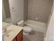 Bathroom with tiled walls and floor, vanity and mirror, toilet, and tub at 4135 Twenty Grand Dr, Indian Trail, NC 28079