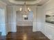 Elegant dining room featuring a decorative chandelier, wainscoting, and hardwood floors at 4135 Twenty Grand Dr, Indian Trail, NC 28079