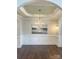 Elegant dining room features a modern chandelier, decorative artwork, and wood flooring at 4135 Twenty Grand Dr, Indian Trail, NC 28079