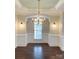 Elegant dining room features a modern chandelier, neutral paint, and wood flooring at 4135 Twenty Grand Dr, Indian Trail, NC 28079