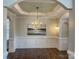 Elegant dining room features a modern chandelier, decorative artwork, and wood flooring at 4135 Twenty Grand Dr, Indian Trail, NC 28079
