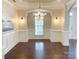 Elegant dining room featuring a decorative chandelier, wainscoting, and hardwood floors at 4135 Twenty Grand Dr, Indian Trail, NC 28079