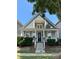 Charming two-story home featuring a welcoming front porch with stone accents and a second-story balcony at 4135 Twenty Grand Dr, Indian Trail, NC 28079