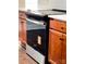 Kitchen stove features stainless steel accents with white countertops and dark-stained cabinetry at 4135 Twenty Grand Dr, Indian Trail, NC 28079