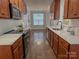 Spacious kitchen flowing into dining area, wooden cabinets, white subway tile backsplash and light countertops at 4135 Twenty Grand Dr, Indian Trail, NC 28079