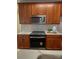 Well-lit kitchen featuring wooden cabinets, modern appliances, white subway tile backsplash, and white countertops at 4135 Twenty Grand Dr, Indian Trail, NC 28079