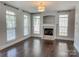 Inviting living room featuring a fireplace, wood flooring, and lots of natural light at 4135 Twenty Grand Dr, Indian Trail, NC 28079