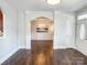 Open living room with hardwood floors flowing into dining area, accentuated by archways and natural light at 4135 Twenty Grand Dr, Indian Trail, NC 28079