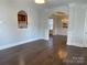 Living room with wood floors, open archway, columns, view to dining room, and natural light at 4135 Twenty Grand Dr, Indian Trail, NC 28079